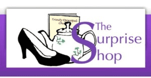 Illustration of a high heel, teapot, and book with "Trinity Episcopal Church" text. "The Surprise Shop" is written in purple.