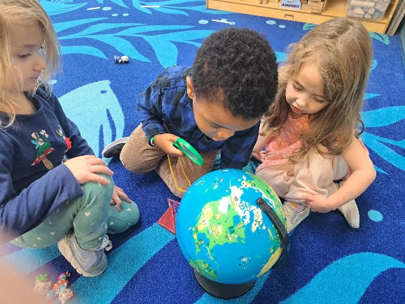 Children learning about geography at Trinity Episcopal Preschool.